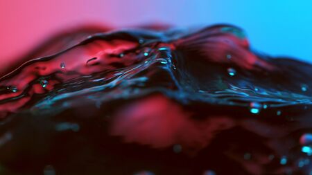 Detail of water waves highlighted by neon lights. Abstract water backgroundの写真素材