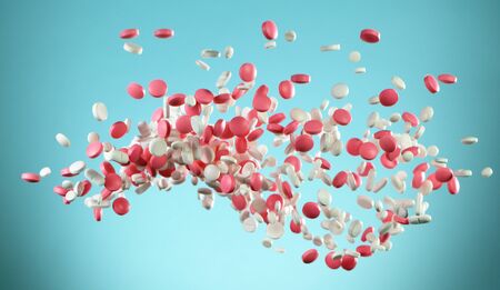 Freeze motion of flying coloured pills on white background. Health and medical conceptの写真素材
