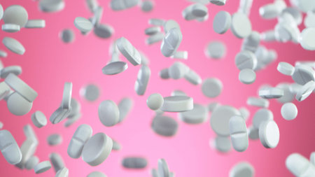 Freeze motion of flying white pills on pink background. Health and medical concept