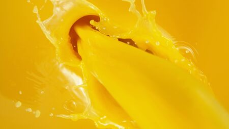 Detail of pouring orange juice, close-up.の写真素材