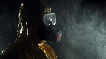 Portrait of a man in chemical suit with respirator and goggles. Concept of protection against...