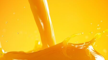 Pouring orange juice splash, isolated on coloured backgroundの写真素材