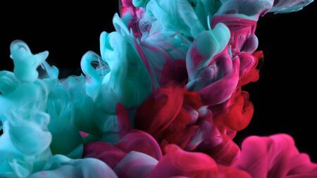 Abstract coloured ink in water, isolated on black backgroundの写真素材