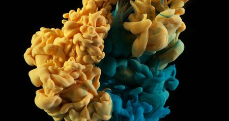 Abstract coloured ink in water, isolated on blackの写真素材