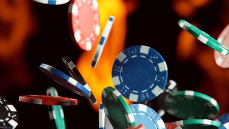 Falling poker chips with flames Isolated on blackの写真素材