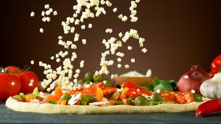 Falling mozzarella cheese on pizza, freeze motion. Italian traditional meal.の写真素材