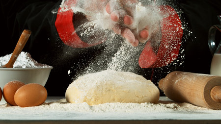 Freeze motion of cooker with clapping hands above yeast dough. Food preparation concept, ingredients...