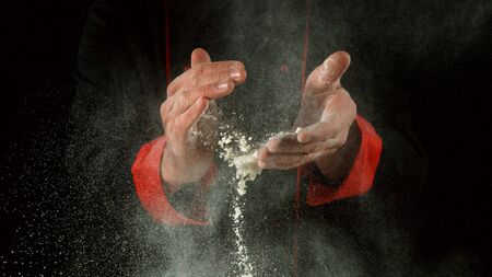 Freeze motion of cooker with clapping hands with flour. Food preparation concept.の写真素材