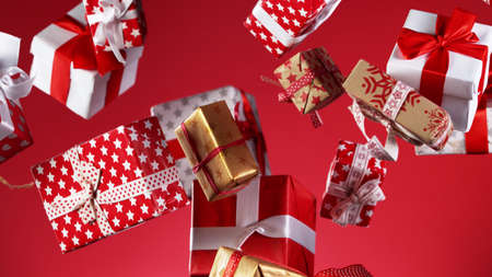 Flying christmas gifts on coloured background, concept of celebrating, studio shot.の写真素材