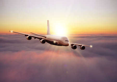 Rising sunset above the clouds, airplane view above the sky
