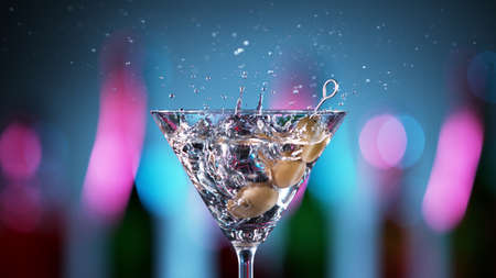 Closeup of two mojito drinks hitting each other in cheers gesture. Bar on background, celebration concept.の写真素材