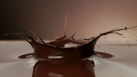 chocolate splash wavy shape, isolated on brown backgroundの写真素材
