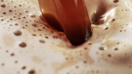 Detail of coffee drink being pour into foamy coffee drink. Abstract coffee background.の写真素材