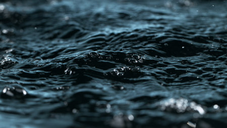 Macro shot of dropping water in dark black colors.