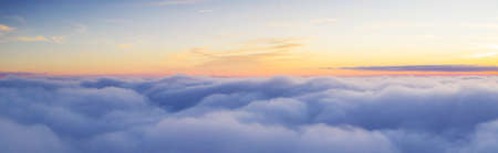 Passengers commercial airplane flying above clouds in sunset light. Concept of fast travel, holidays and business.の写真素材