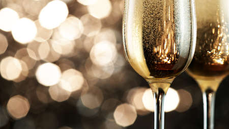 Two champagne glasses filled with bubbling wine. Macro shot, celebration and New Year concept.の写真素材