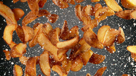 Champagne bottle beying opened. Concept of celebration New Year, birthday or success. Studio shot, freeze motion, bright golden background.の写真素材