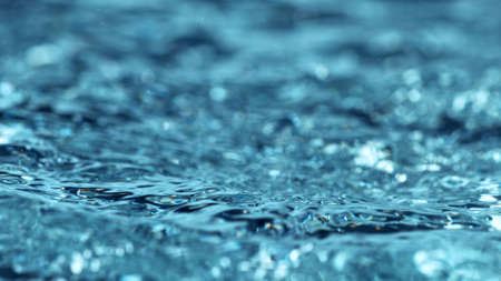 Blue water waves abstract background, free space for text.の写真素材