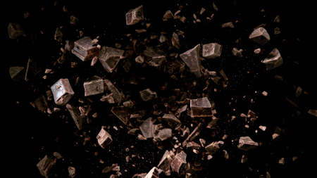 Freeze motion of flying group of cocoa beans. Isolated on black backgroundの写真素材