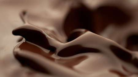 Detail of splashing melted chocolate. Macro shot, food background.の写真素材