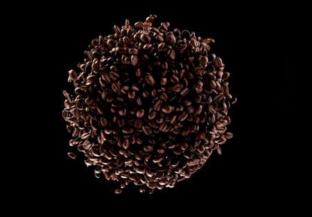 Freeze motion of flying coffee beans in twister shape, isolated on black background.の写真素材