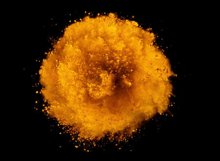 Explosion of brown powder on black background. Freeze motion of abstract shape.の写真素材