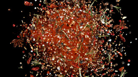Explosion of brown powder on black background. Freeze motion of abstract shape.の写真素材