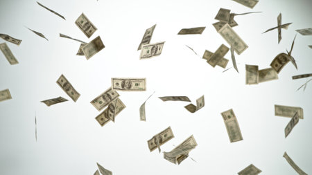Close-up of screaming businessman with flying dollars banknotes isolated over gray backgroundの写真素材