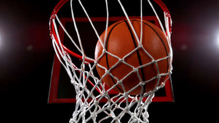 Basketball basket on black backgorund, detail shot, dark background with spot lights.の写真素材