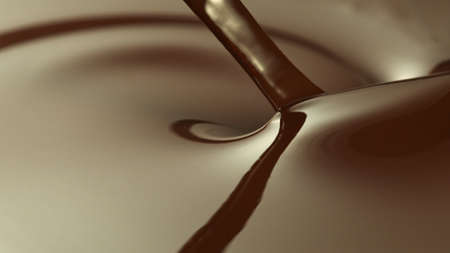 Close-up of stirring stream of melted chocolate, creating smooth shapes.の写真素材