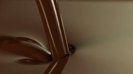 Close-up of pouring stream of melted chocolate, creating curly shapes.の写真素材
