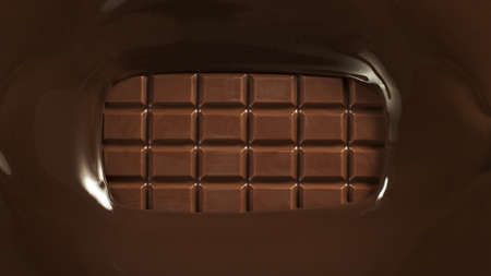 Close-up of pouring stream of melted chocolate, creating curly shapes.の写真素材