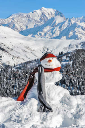 Snowman in a scarf and a a cap on a background of Mont Blancの写真素材
