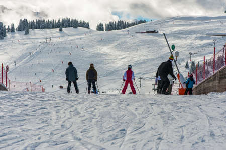 People come down from the mountain on skisの写真素材