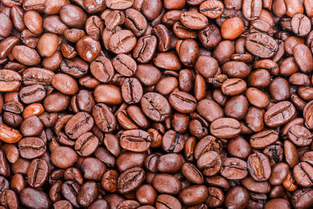 Roasted Coffee beans scattered on the backgroundの写真素材