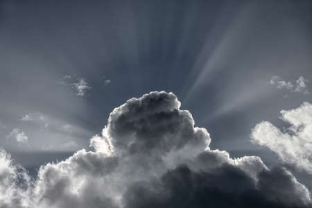 sunbeam behind a cloudの写真素材