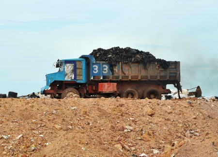 Garbage Trucks work on the landfillの写真素材