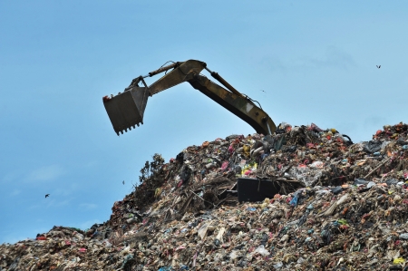 excavator works on the landfill の写真素材