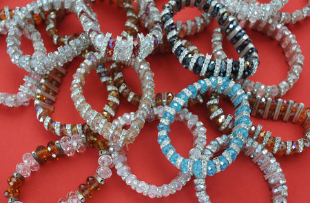 Colourful fashion bracelets on a red background 