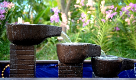 stone fountain with water fall decorationの写真素材