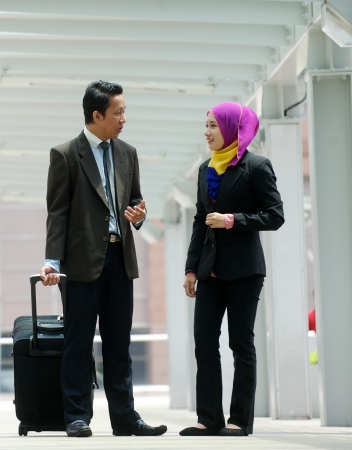 Young business couple discuss in walk way の写真素材