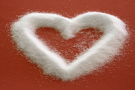 Sweet Heart - Sugar in a heart shape on redの写真素材