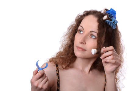 Woman in hair rollers isolated on whiteの写真素材