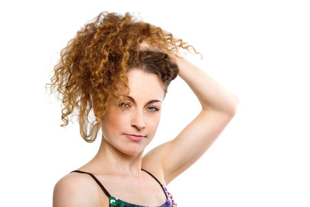 Sensual portrait of beautiful confident young woman against white background