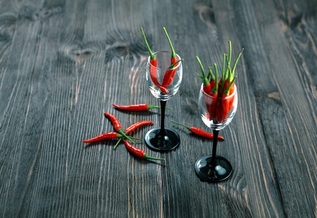 Red pepper on old wooden table.の写真素材