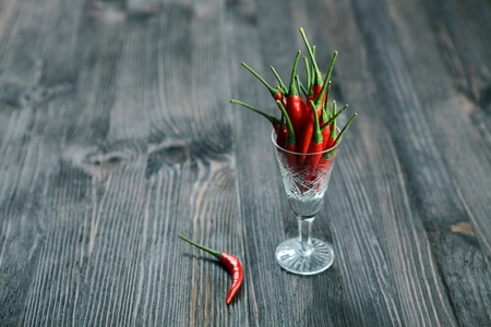 Red pepper on old wooden table.の写真素材