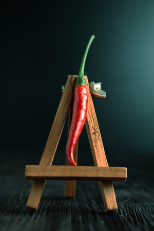 Red pepper on old wooden table.の写真素材