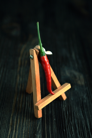 Red pepper on old wooden table.の写真素材