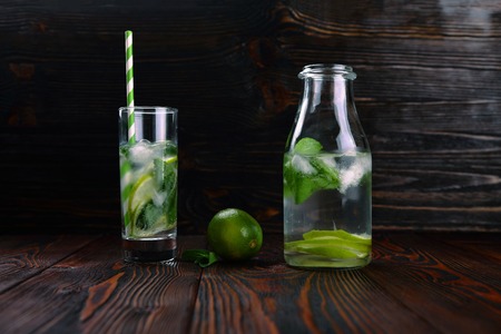 lemonade with lime and ice on a wooden backgroundの写真素材