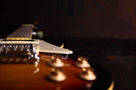 Old electric guitar on wooden table and background